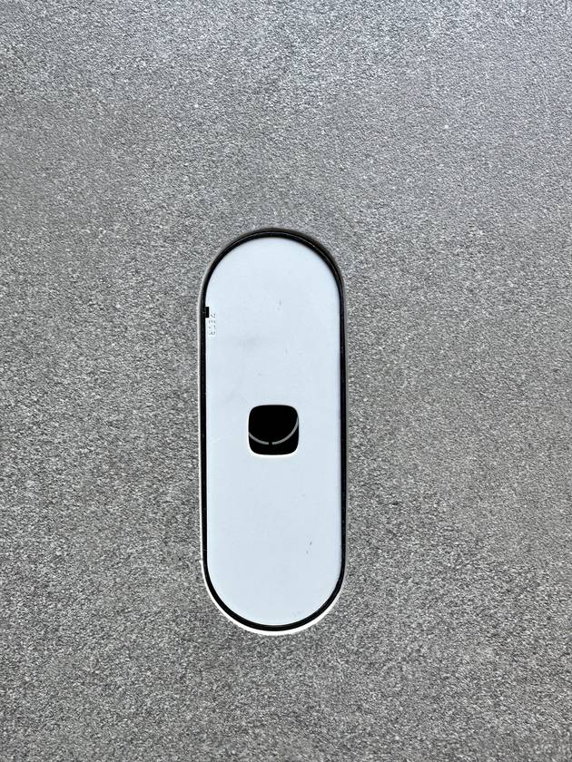 Cut-outs to fit: A power outlet set flush in a big slab, cut clean to its shape.