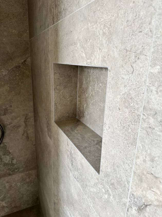 Niche, lined up: Set to the tile joints, every edge finished clean.